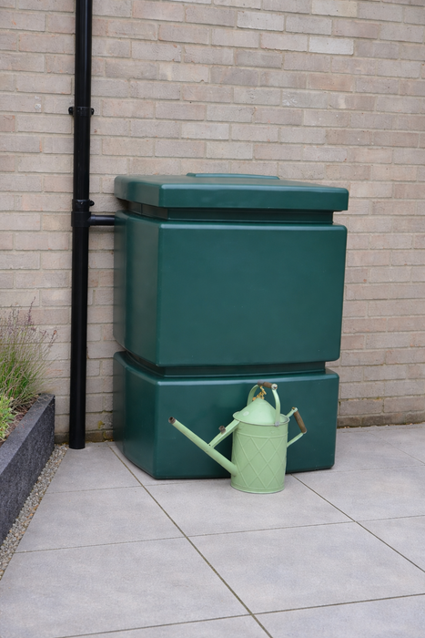 large green water butt on patio
with a haws watering can