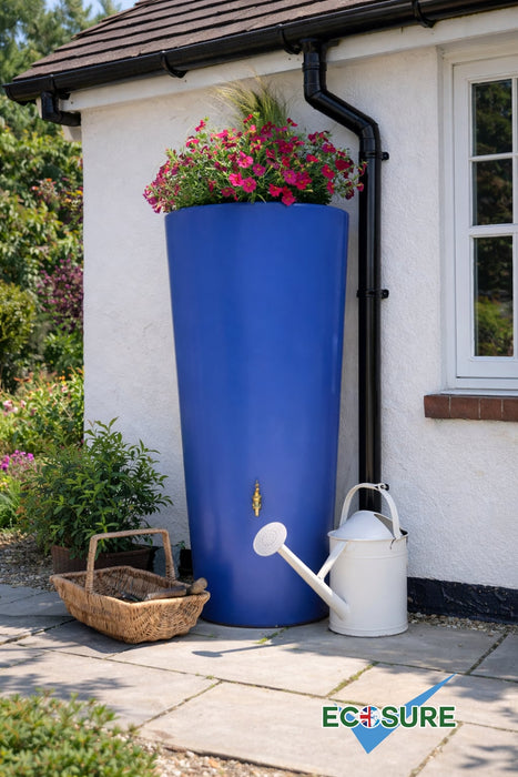 Blue rainwater harvesting tank with flowers and a watering can on a house exterior.