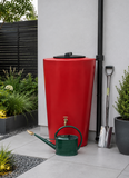 Red rainwater harvesting tank with a green watering can on a patio