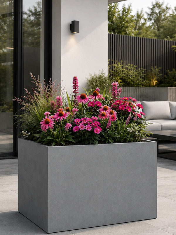 Galvanised planter with pink flowers on a patio
