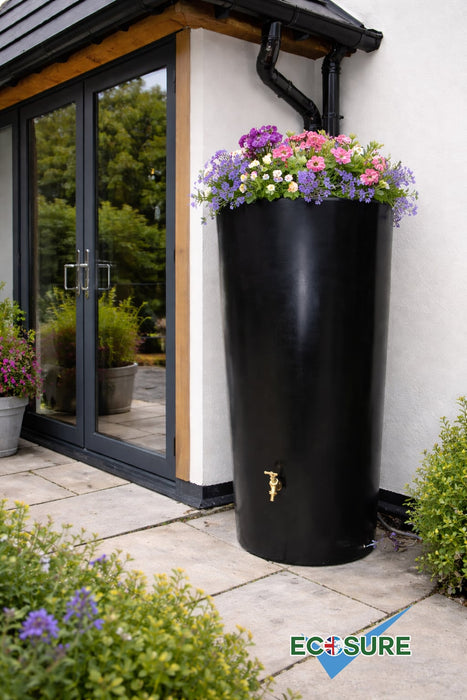 Black rainwater harvesting tank with flowers on top in a garden setting, featuring the Ecosure brand.